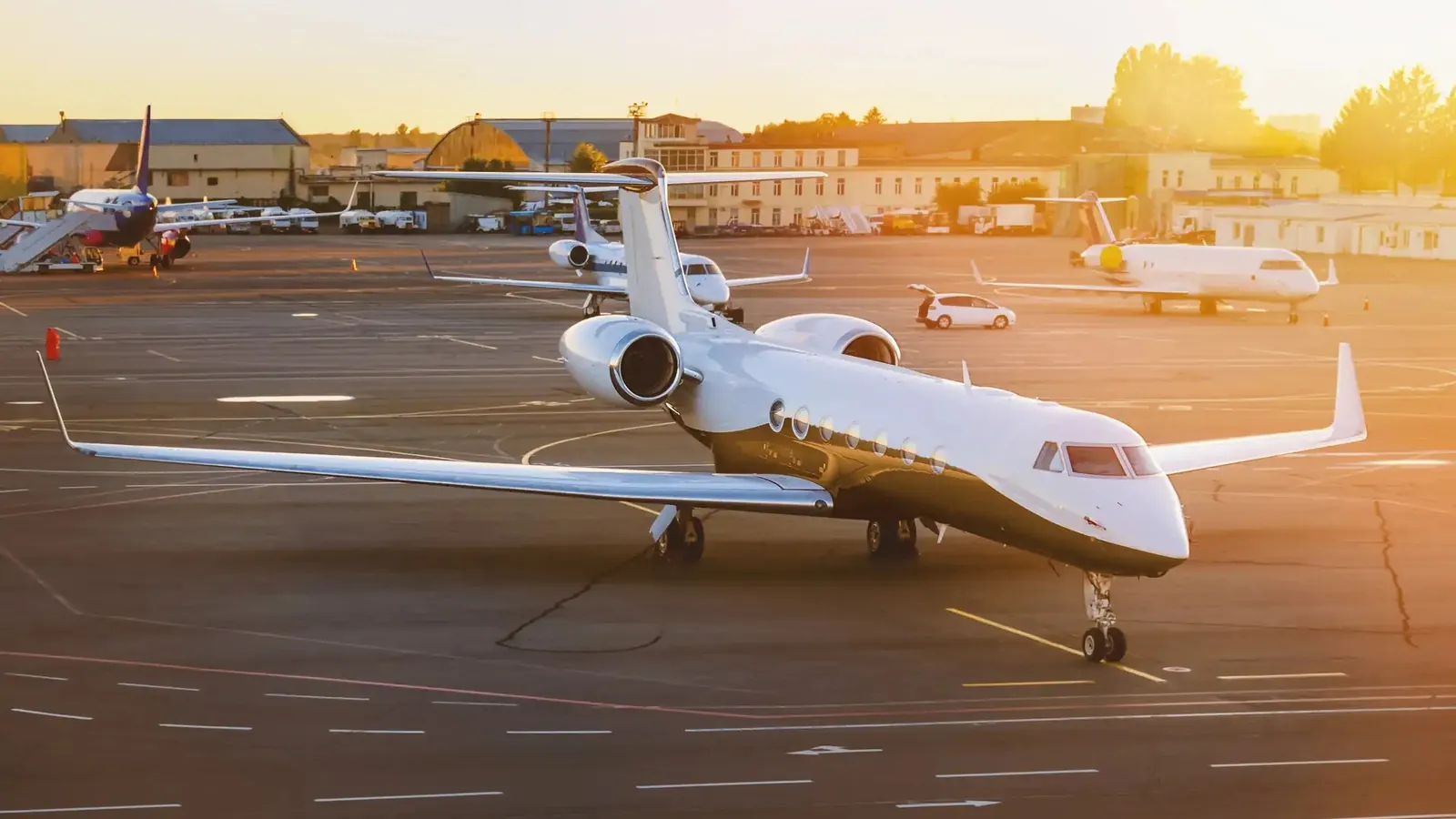A private jet parked on the apron with its airstair lowered