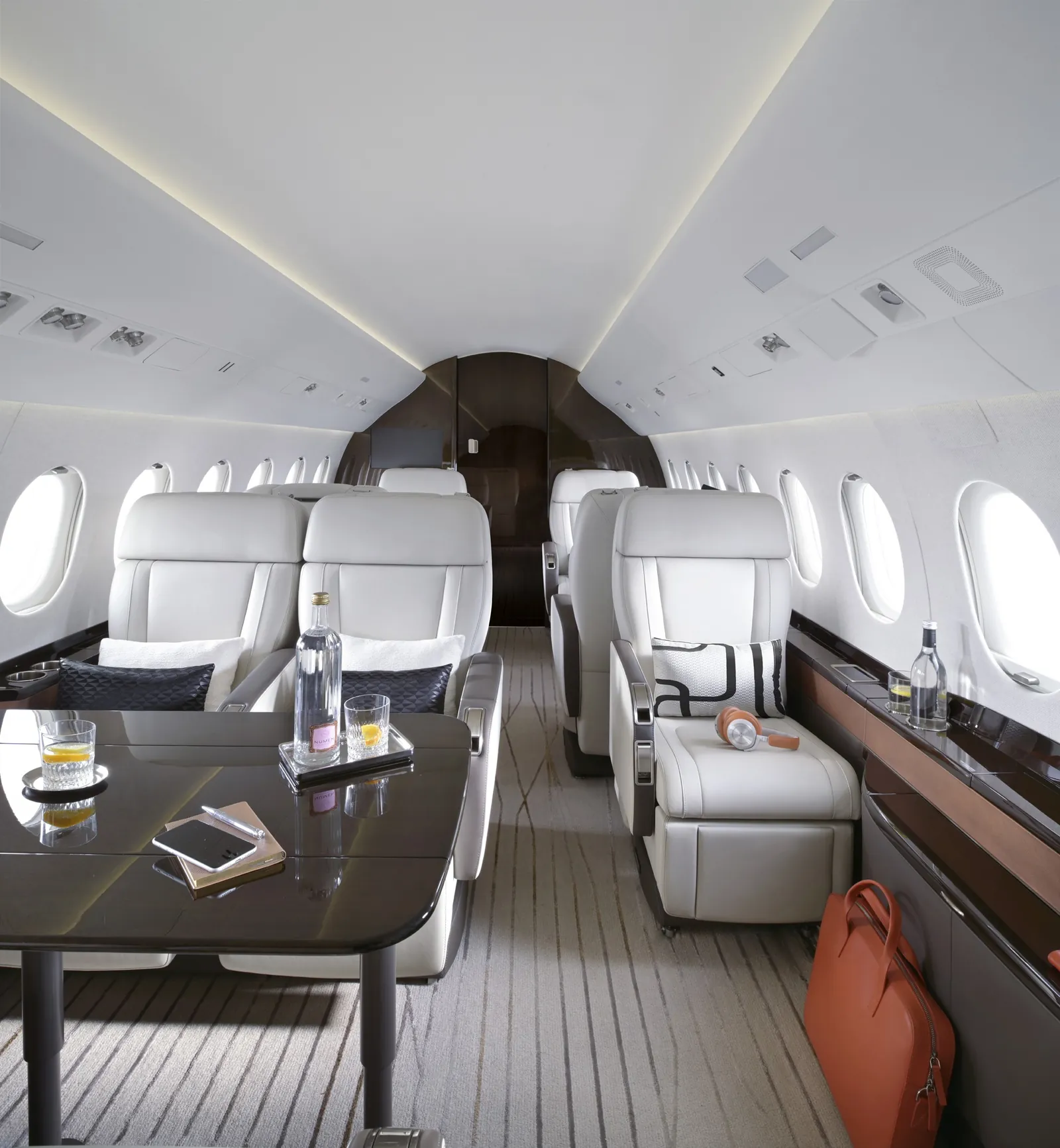 Cabin of the Dassault Falcon 2000LXS with white leather club seats around a table